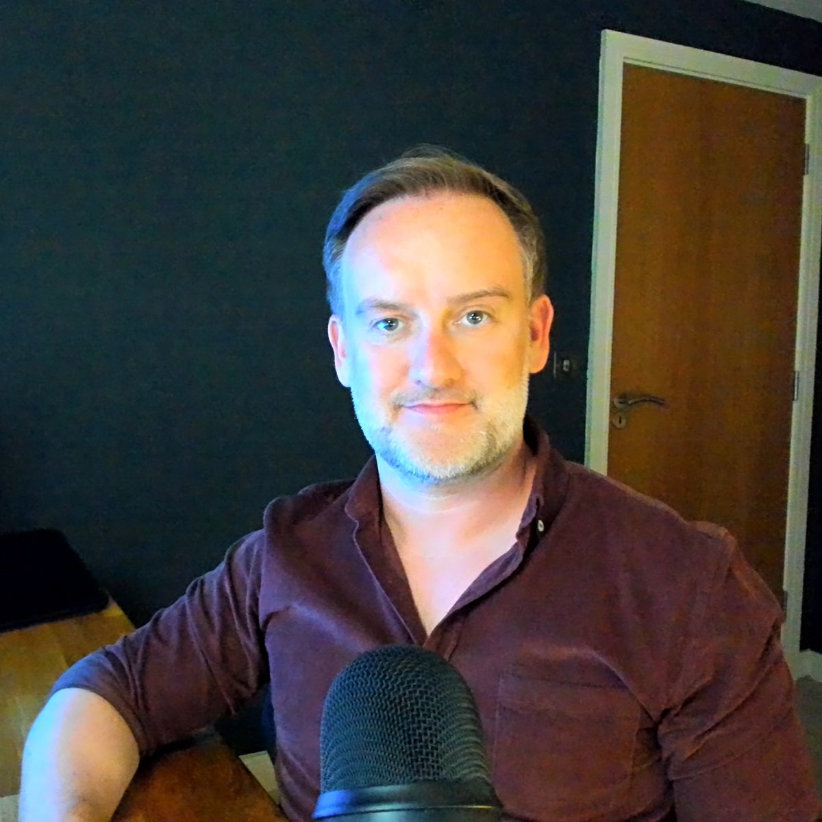 David O'Grady at his desk with a microphone, where he writes every edition of the HR as Coach Newsletter