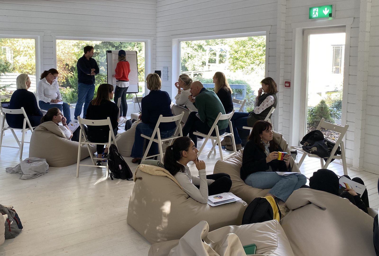 A team in relaxed conversation at an off-site workshop