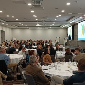 David O'Grady presenting a team's group profile results to a room of delegates