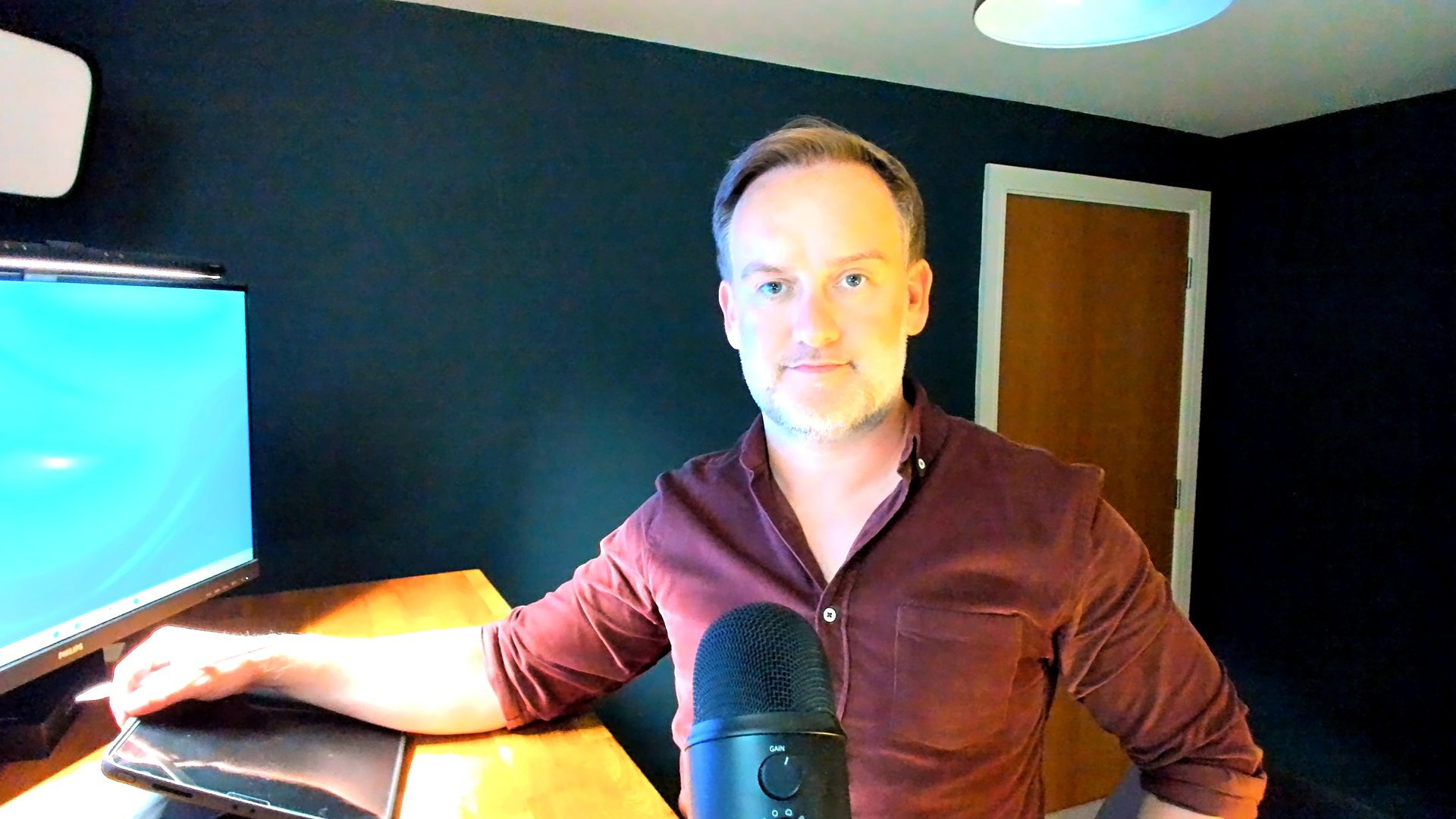 David O'Grady in his coaching studio, pencil on his iPad, microphone and screen set up to run a live virtual team session
