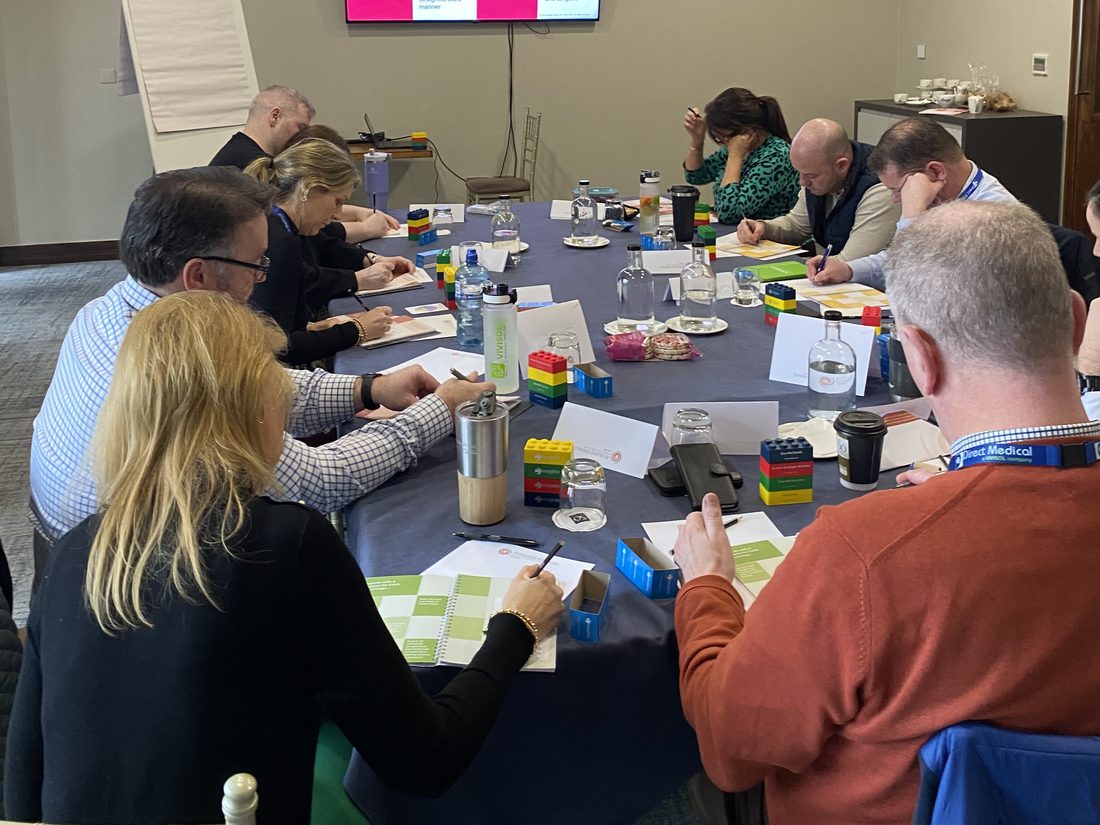 A team around the table applying the Insights colour energies during a session