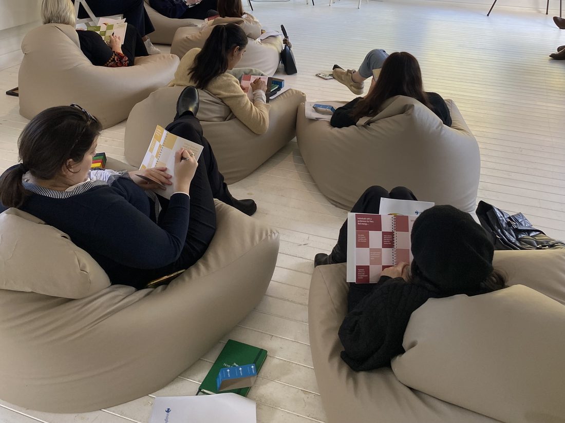 A leadership team working through their Insights Discovery profiles in a bright workshop room